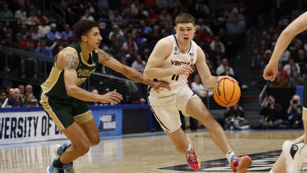 Virginia Cavaliers guard Isaac McKneely (11) dribbles the ball defended by Colorado State Rams guard Nique Clifford (10) in the first half of the NCAA Tournament play-in game at UD Arena in Dayton, Ohio.